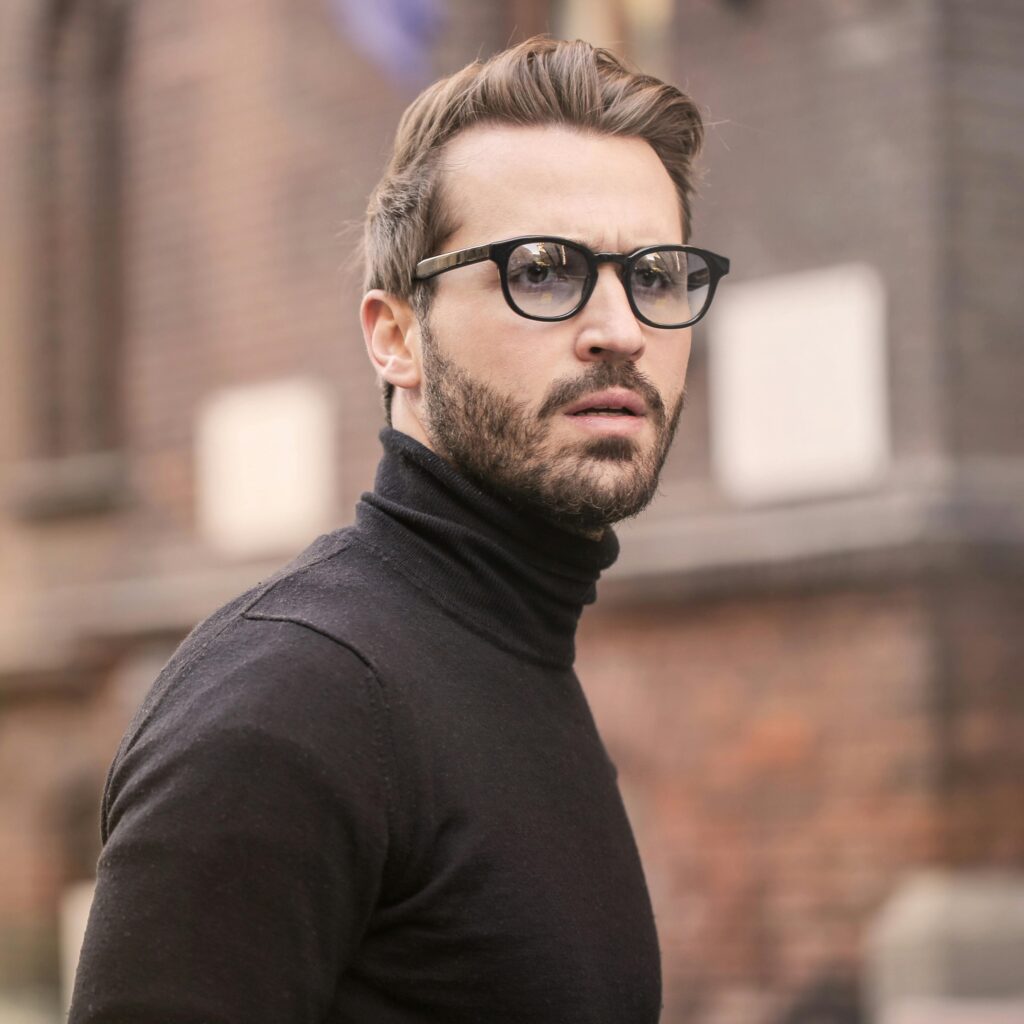 A fashionable man with glasses and a beard captured outdoors in Budapest.